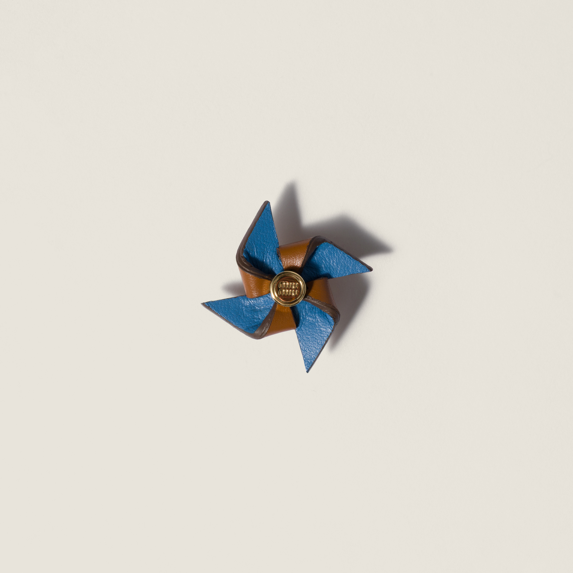 Leather pinwheel brooch